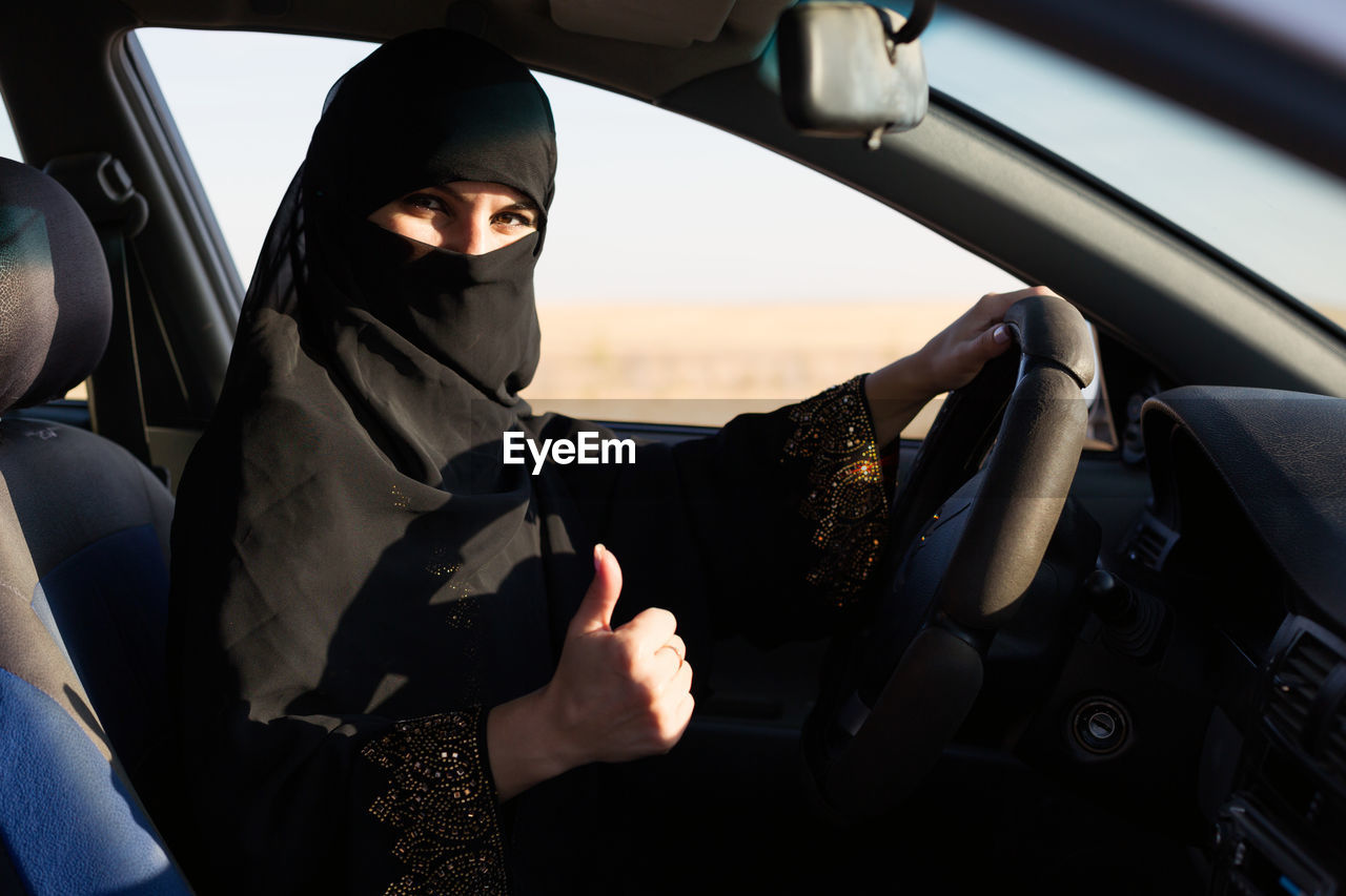 Portrait of woman sitting in car