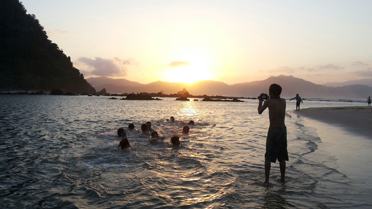 PEOPLE AT BEACH DURING SUNSET