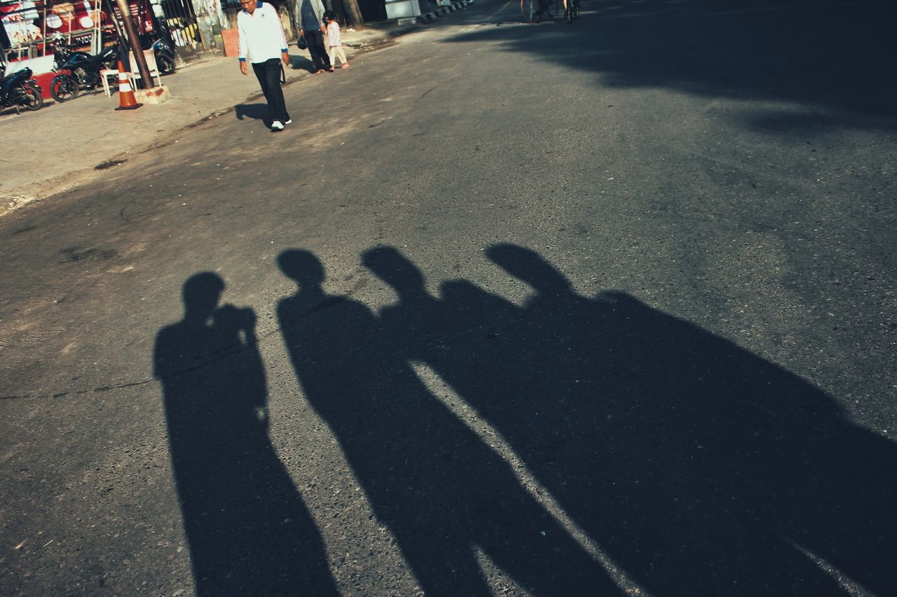 SHADOW OF PEOPLE ON STREET