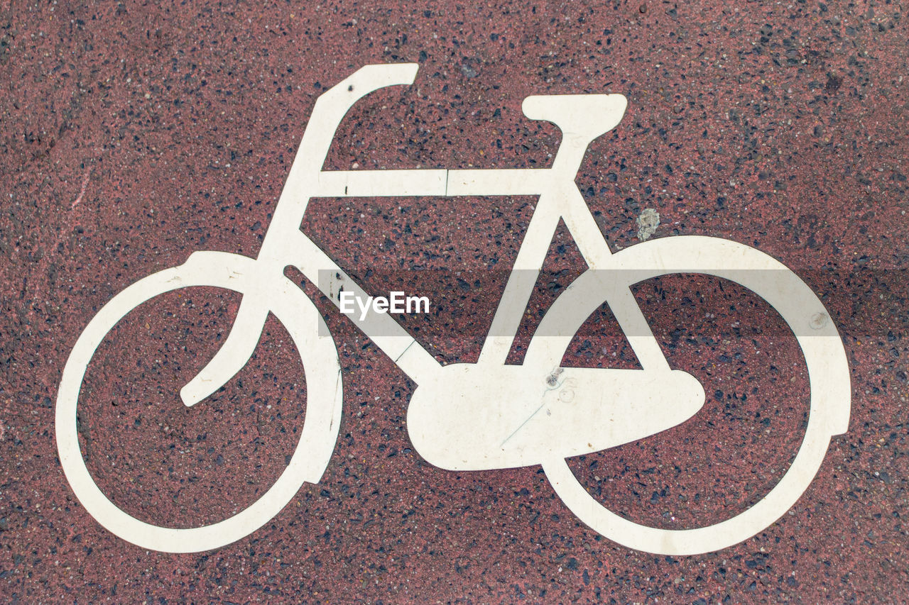 Directly above shot of bicycle lane symbol on road