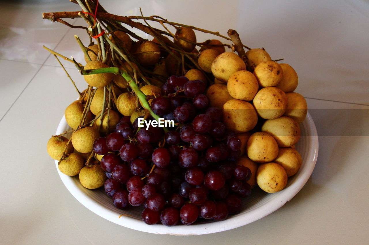 Close up longkong red grapes and longan in white dish