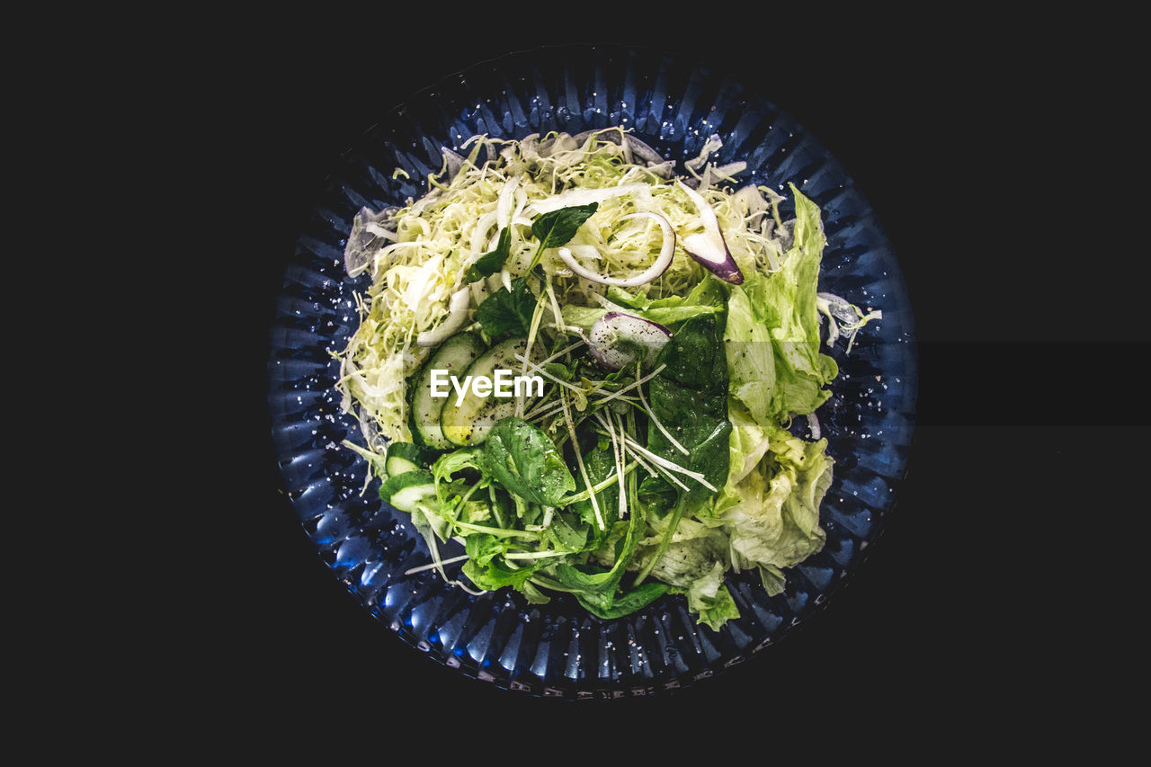 Close-up of salad in bowl against black background