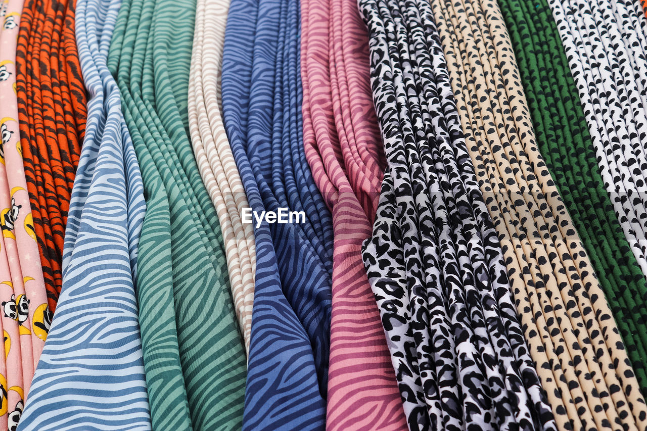 Detailed close up view on samples of cloth and fabrics in different colors found at a fabrics market