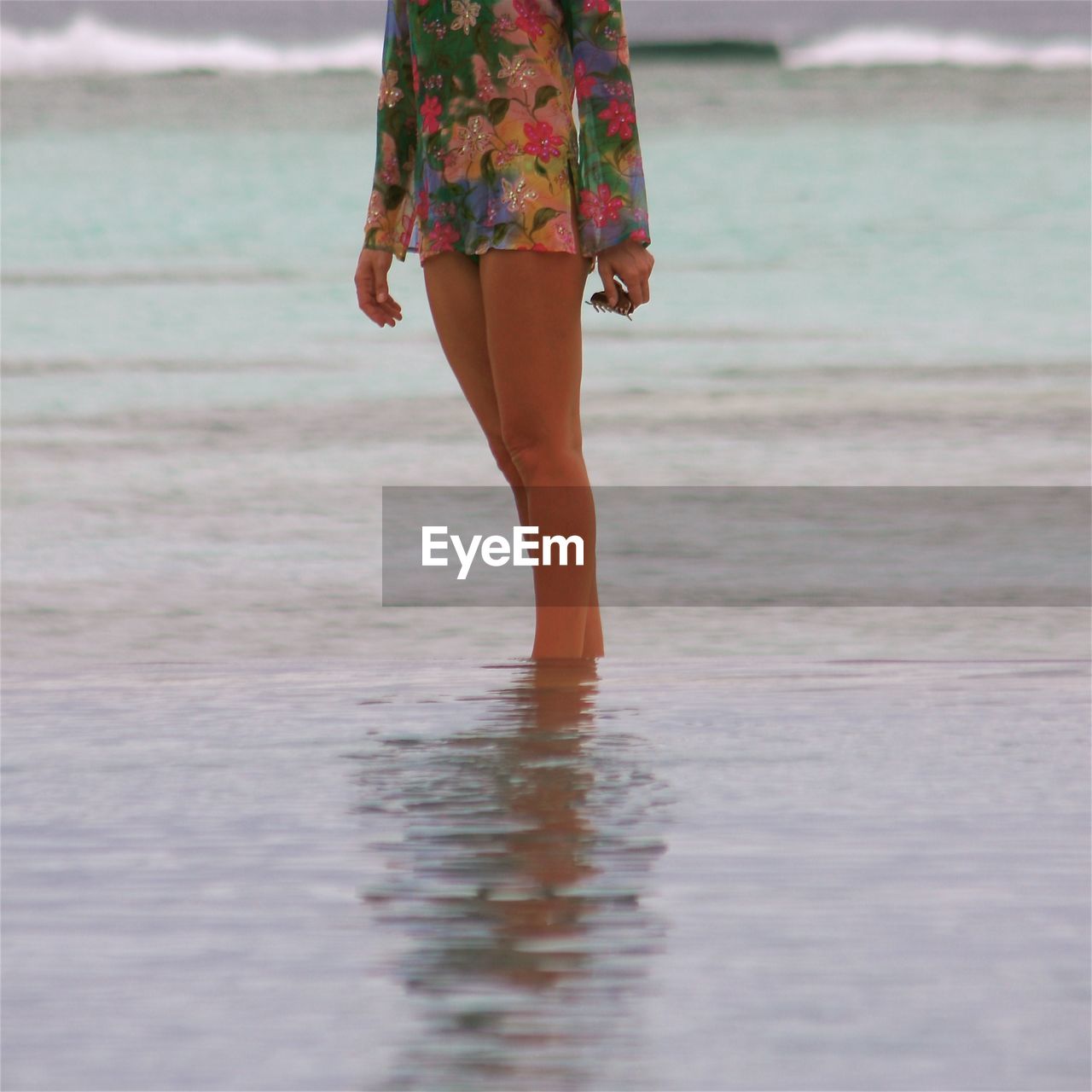 Midsection of woman standing in sea