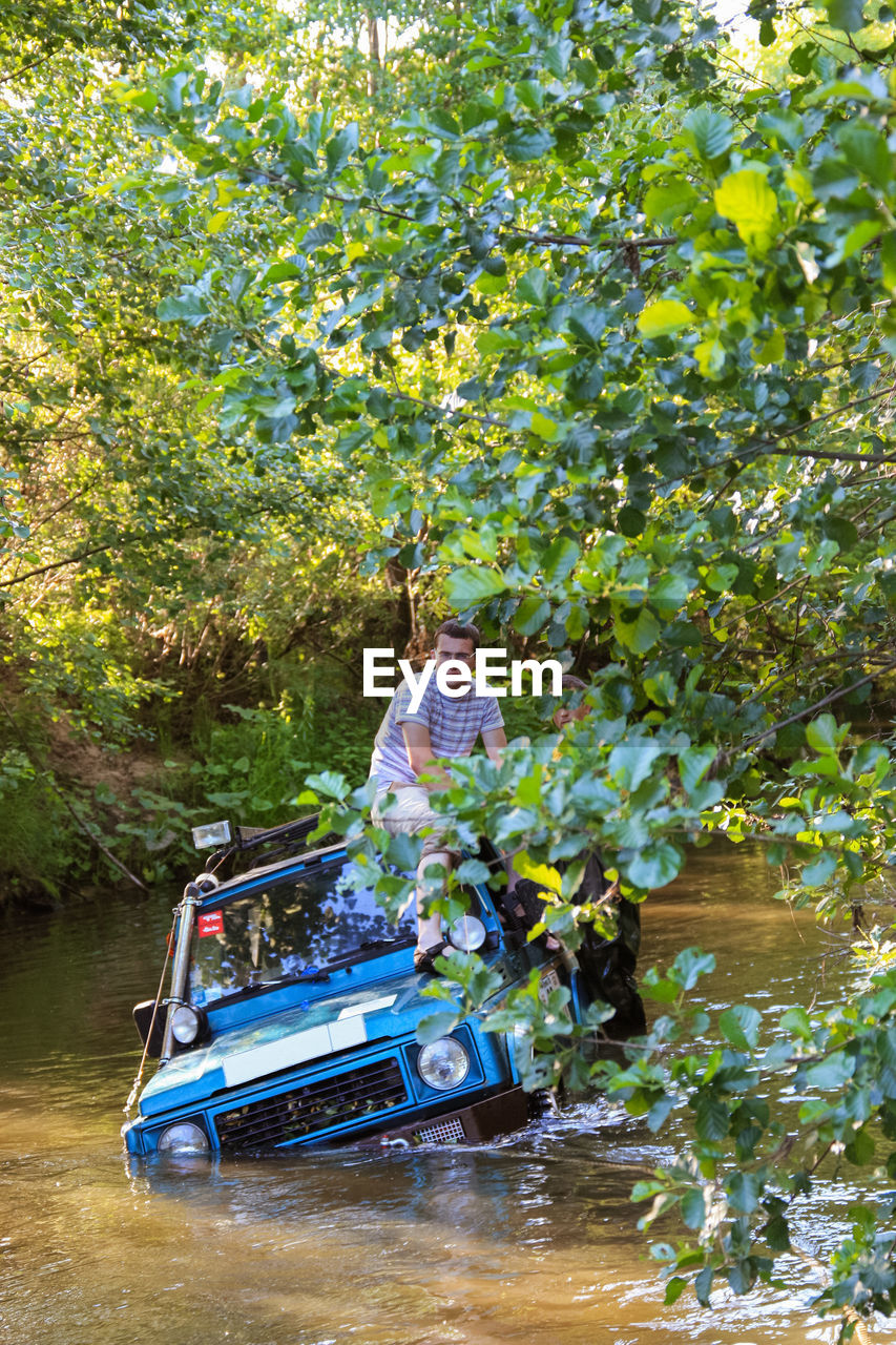 plant, river, water, transportation, tree, nature, mode of transportation, day, men, adult, nautical vessel, leisure activity, vehicle, waterway, outdoors, growth, travel, lifestyles, forest, women, two people, full length, sitting, beauty in nature, adventure, vacation, trip, holiday, person