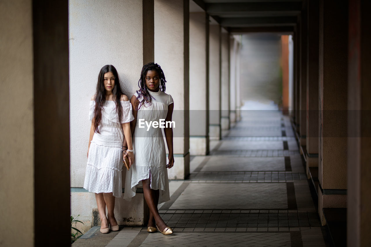 Woman standing in corridor of building