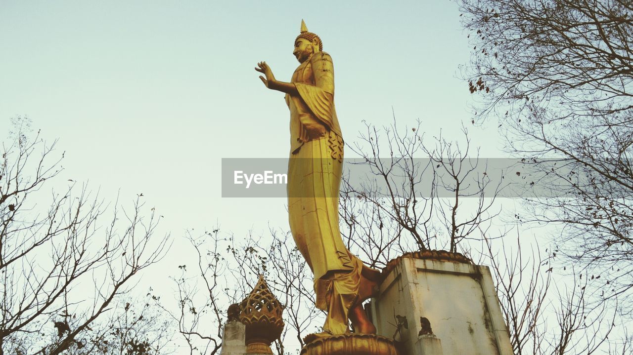 Low angle view of buddha statue at wat tham khao rup chang