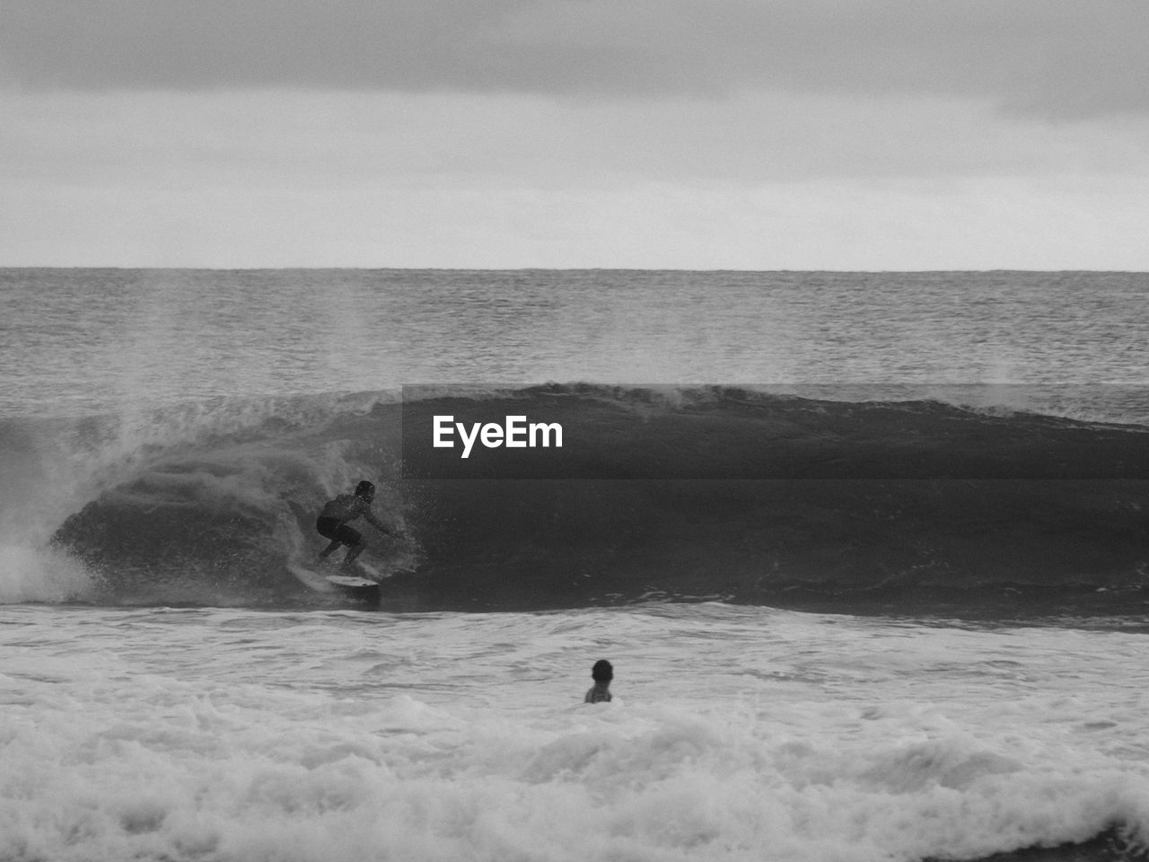 Man surfing at sea against sky