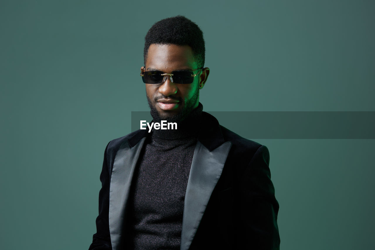 low angle view of young man standing against clear sky