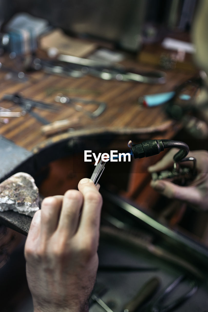 Cropped hand of man working in workshop