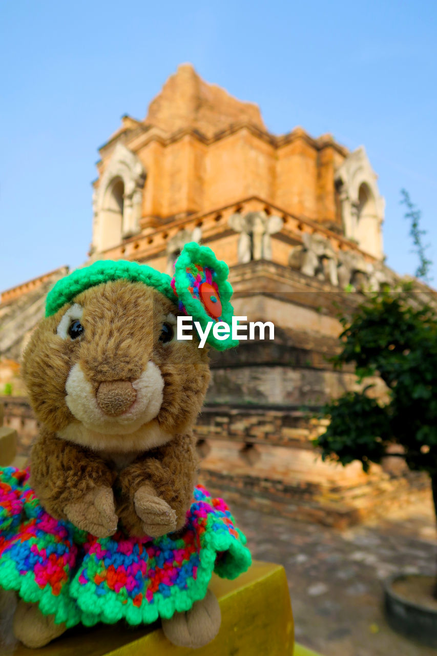 Close-up of stuffed toy on wall against temple