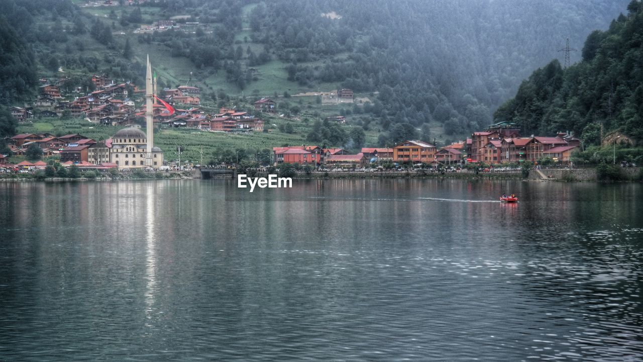 SCENIC VIEW OF RIVER AND HOUSES