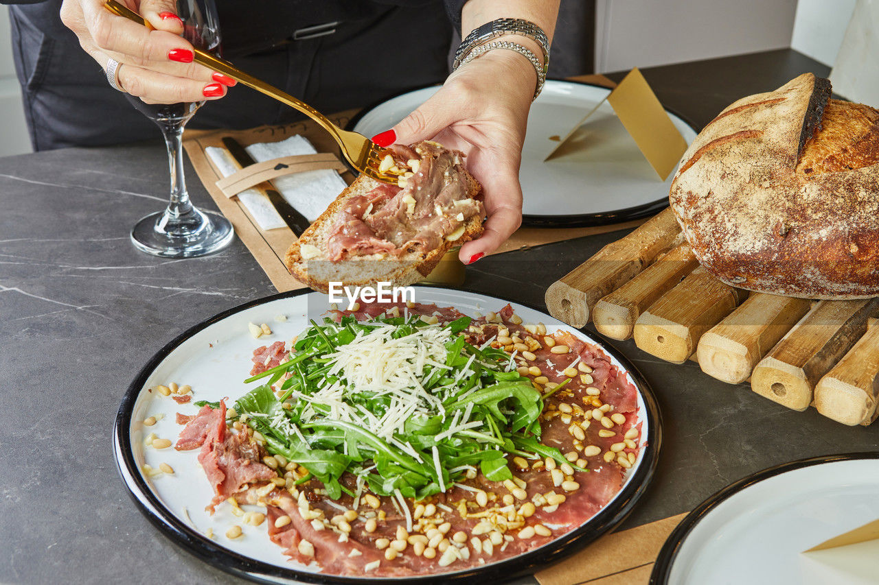 cropped hand of food in plate