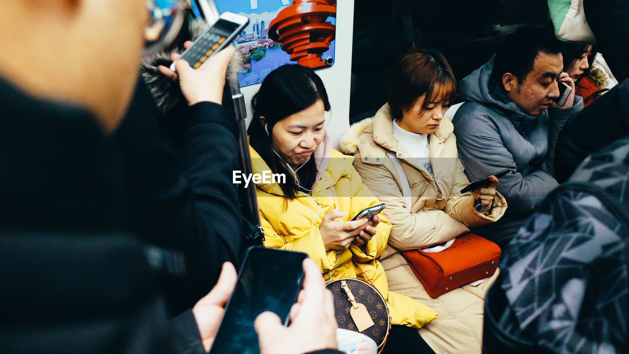 GROUP OF PEOPLE STANDING BY BUS