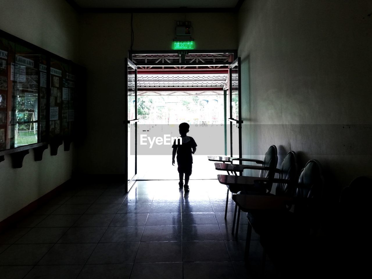 Rear view of silhouette man standing in building