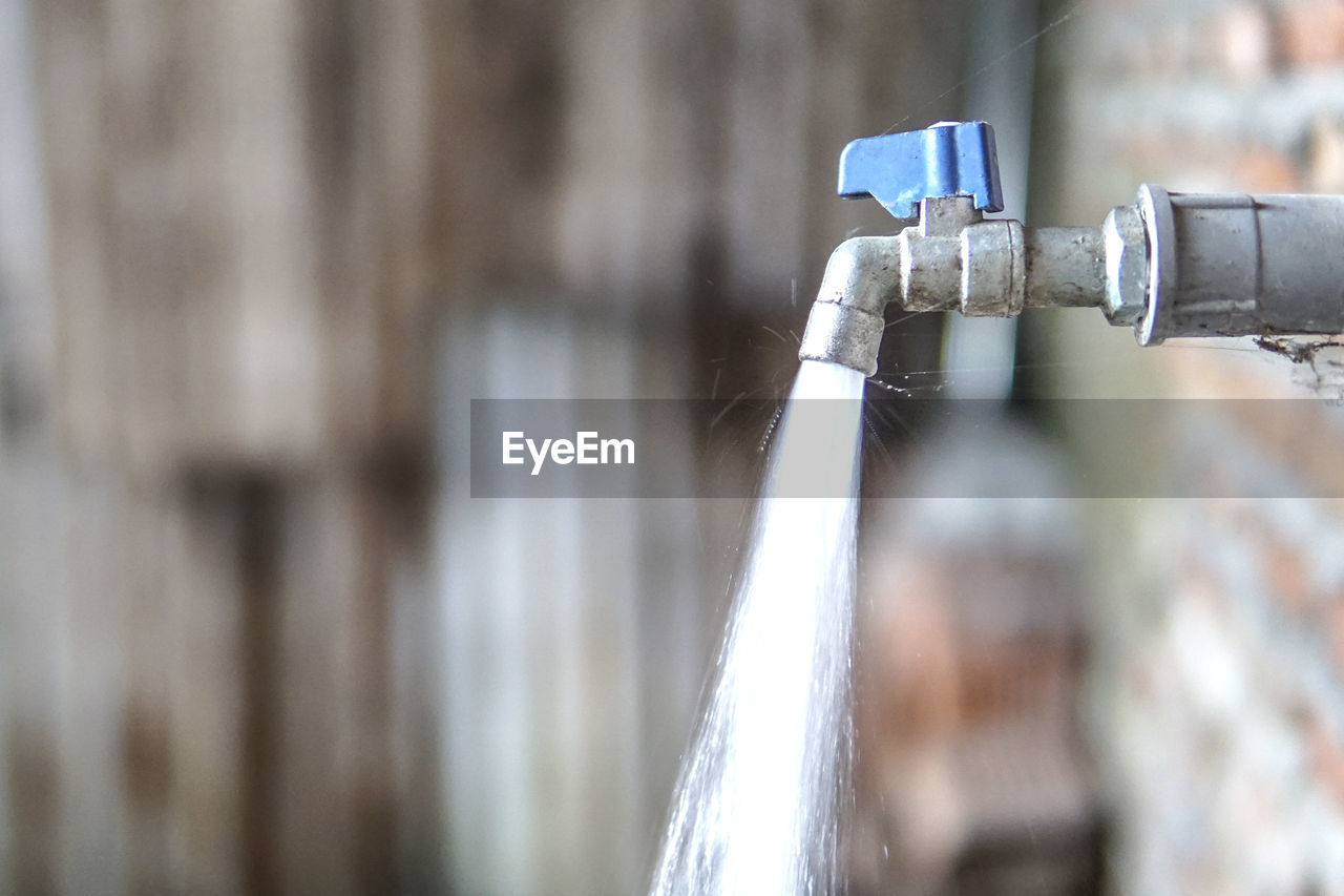 Close-up of running water coming out from faucet