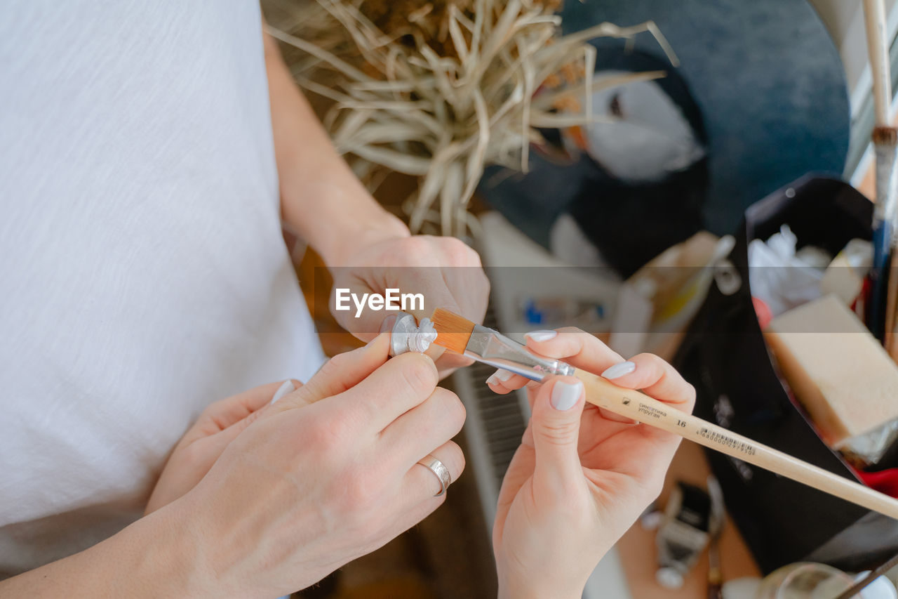 Cropped hand of woman holding syringe