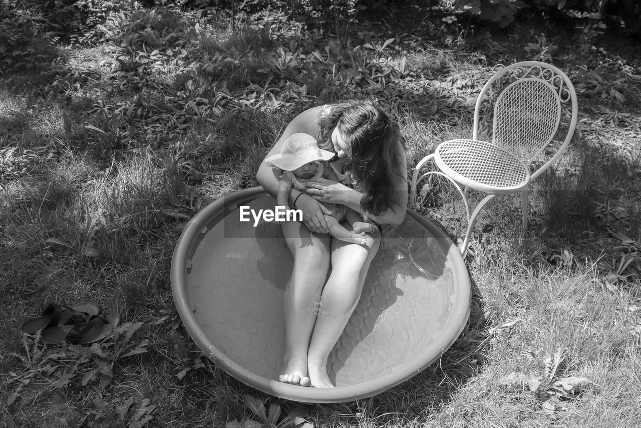 HIGH ANGLE VIEW OF GIRL WEARING SUNGLASSES ON FIELD