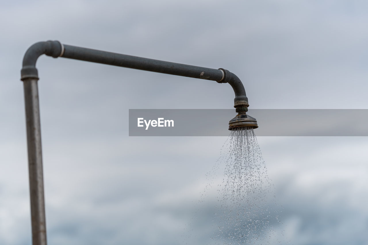 CLOSE-UP OF WATER DROP FROM PIPE
