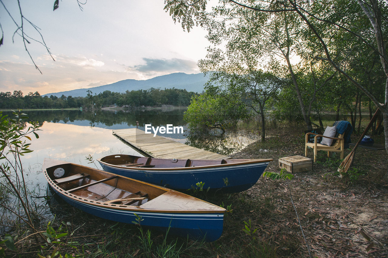 Scenic view of river by trees against sky