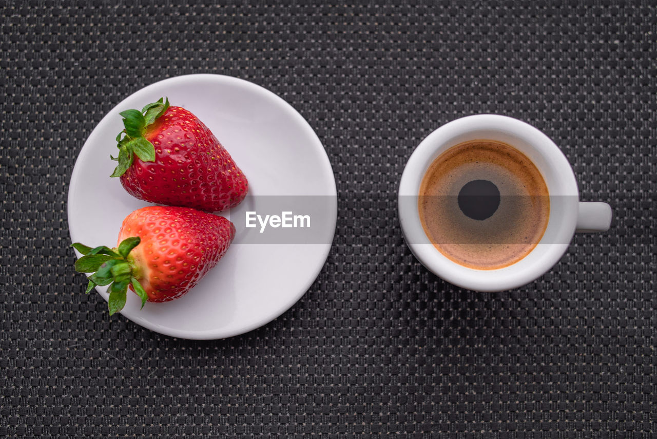 A cup of coffee with some strawberry on different background