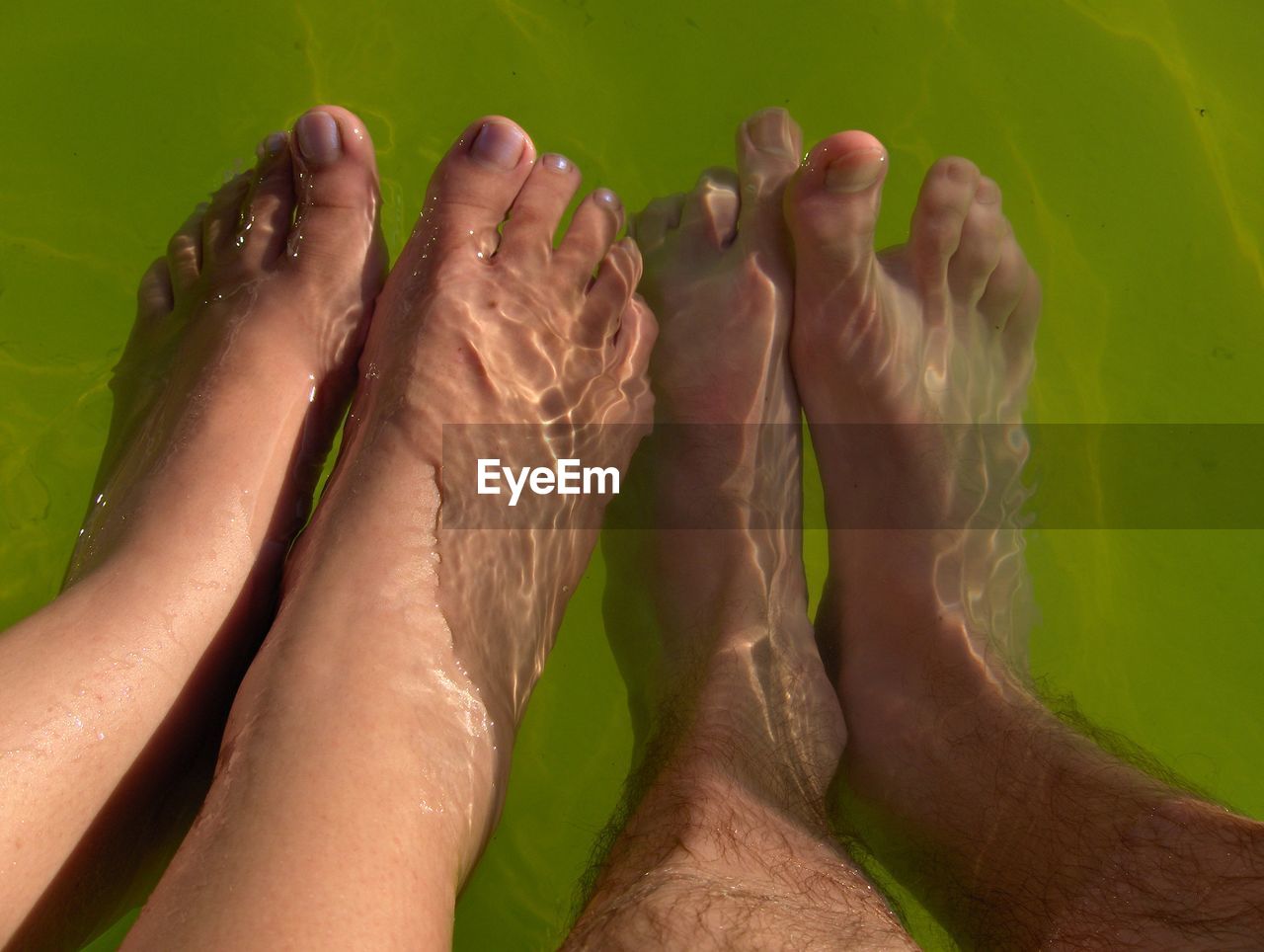 Foot of people relaxing in water