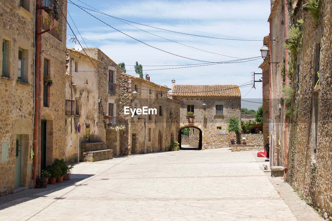 Street amidst buildings against sky