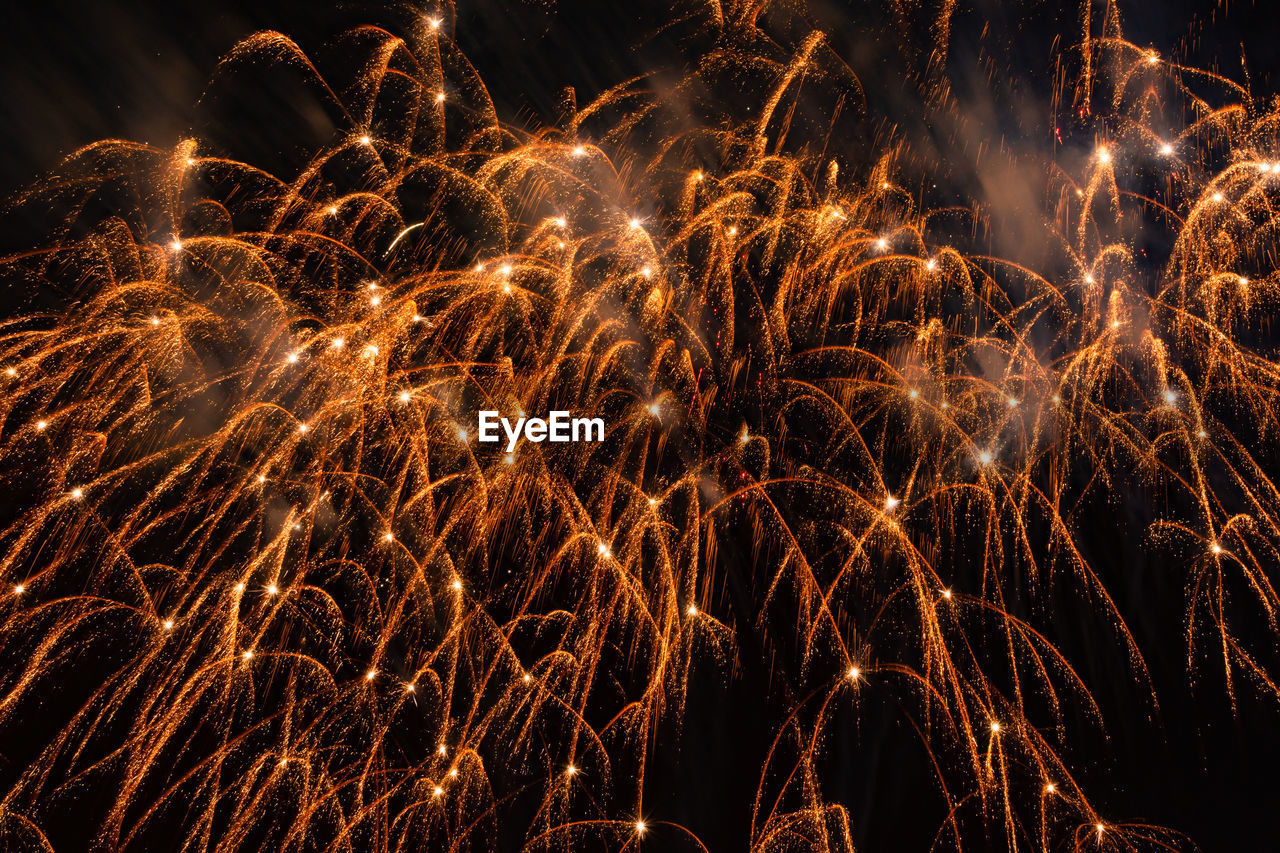 Low angle view of firework display at night