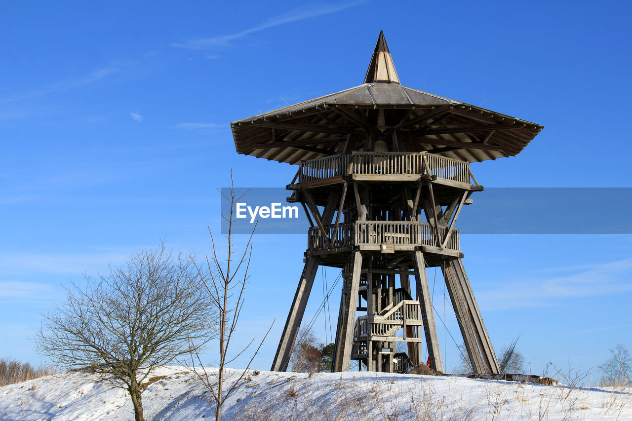 Wooden built observation town against sky