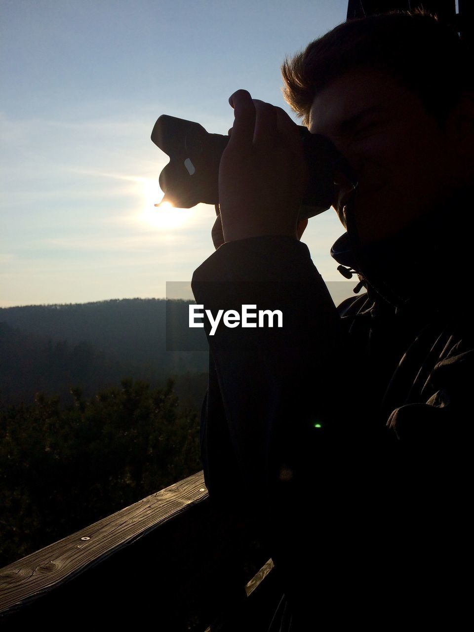 Close-up of man looking through binoculars