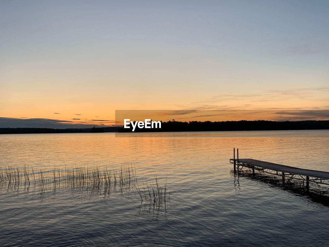 Scenic view of lake against sky during sunset