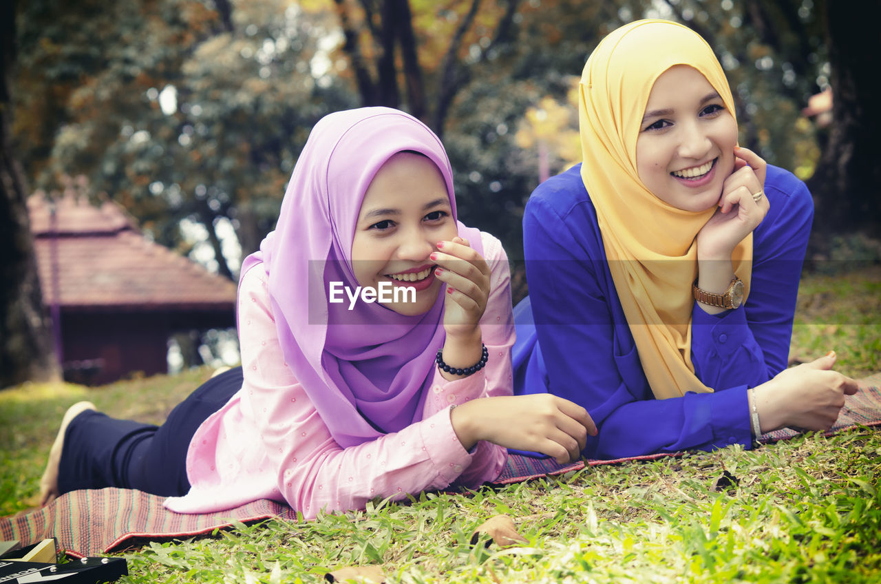 Portrait of a smiling girl sitting outdoors