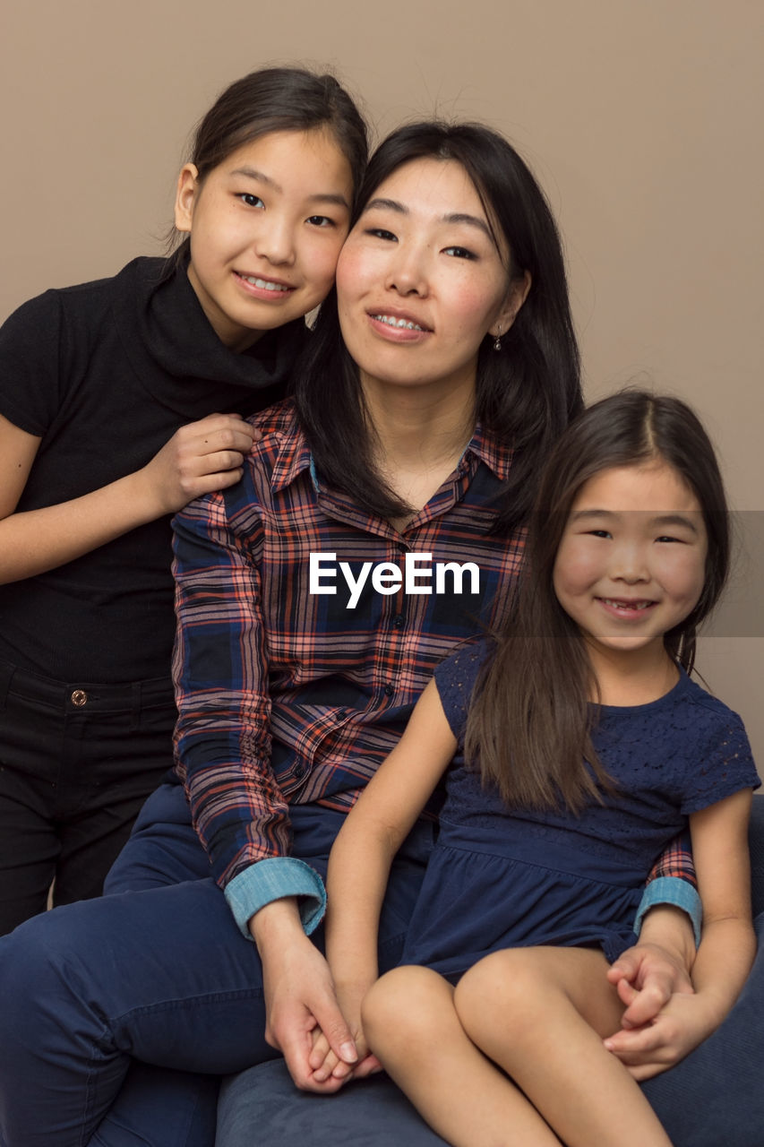 Portrait of smiling mother with daughters