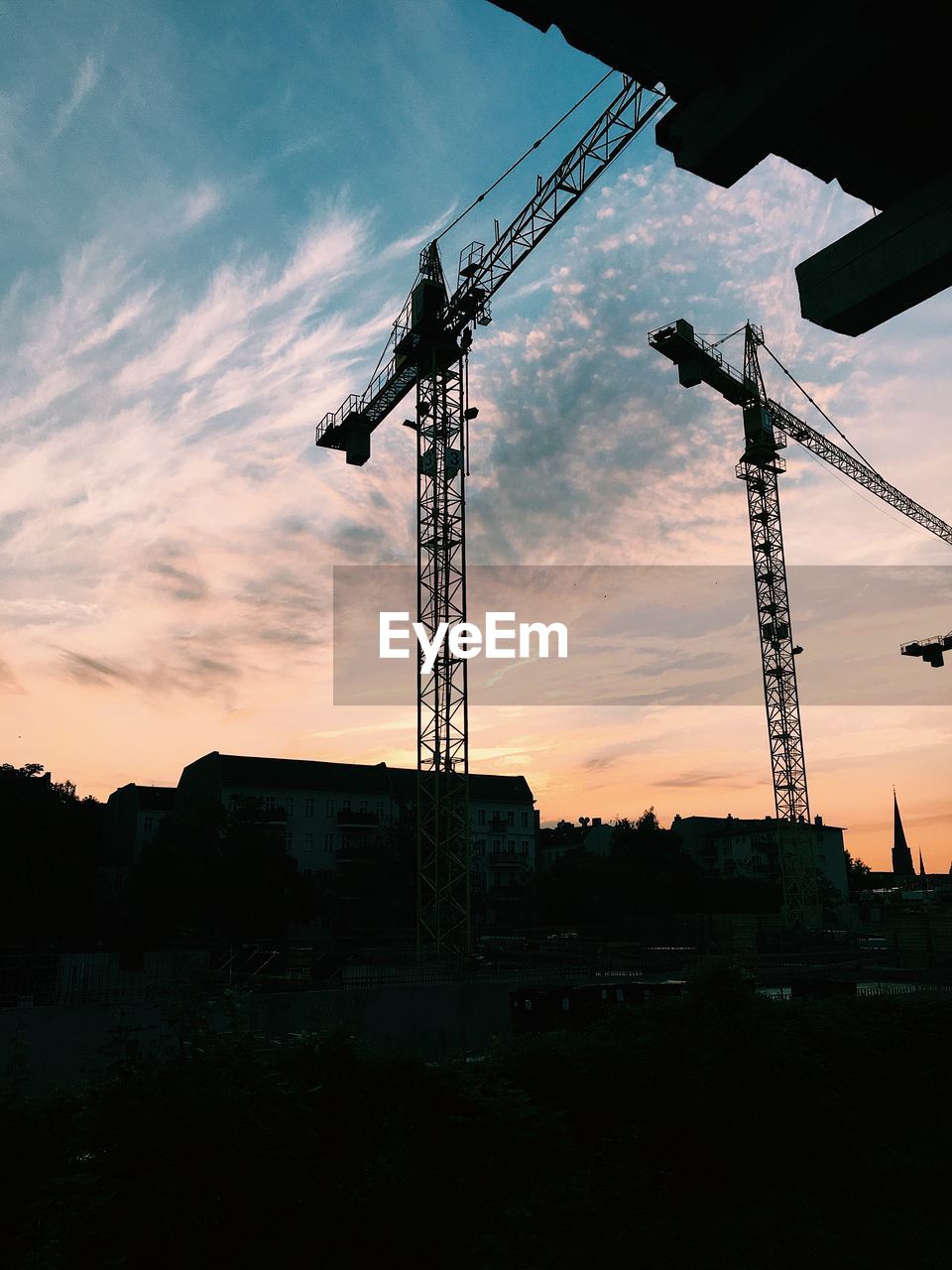 LOW ANGLE VIEW OF SILHOUETTE CRANE AGAINST SKY