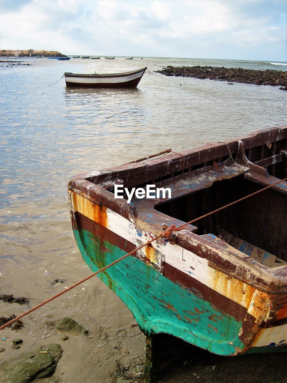 Boat moored on sea against sky