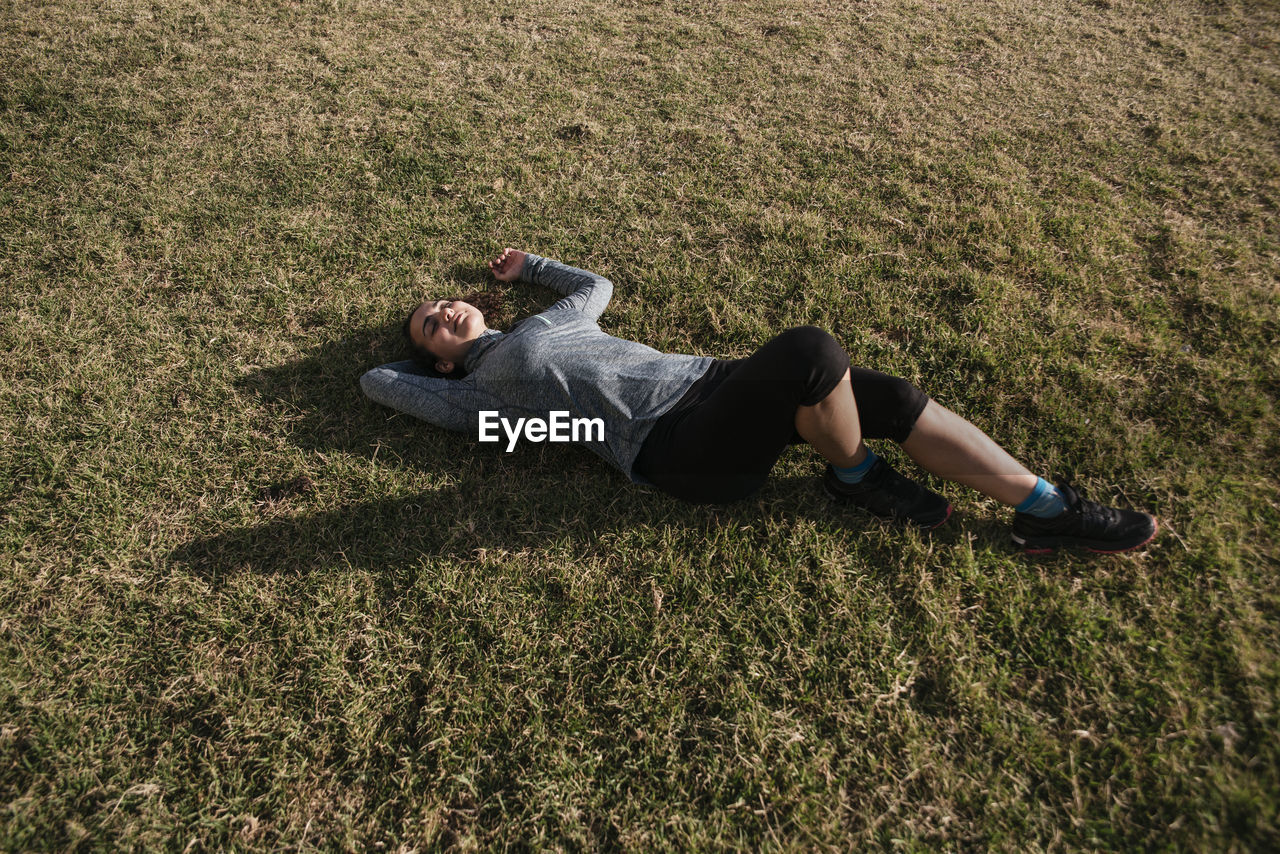 Woman lying down after exercise outdoors