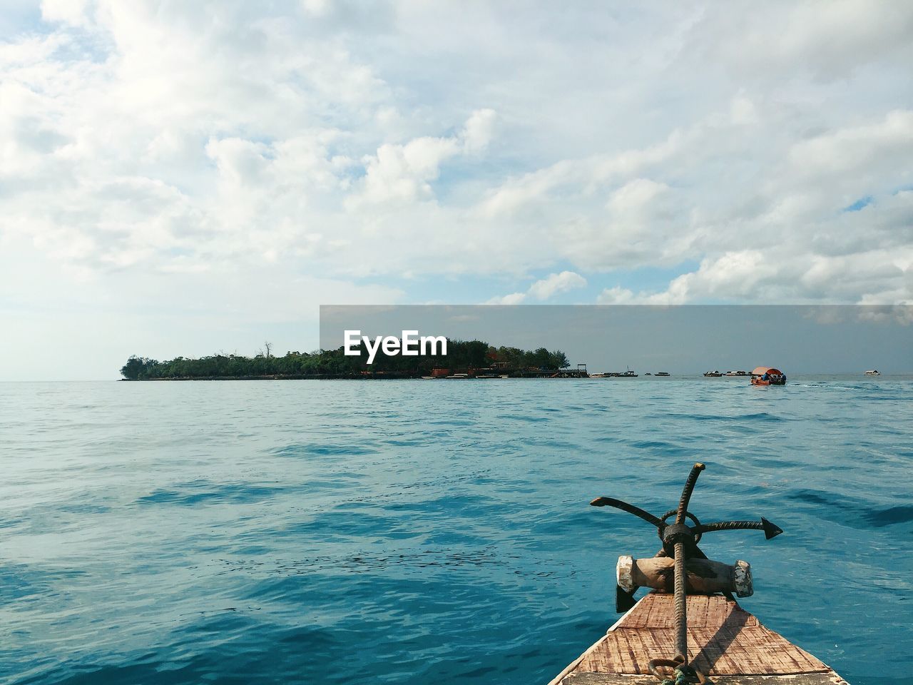 VIEW OF BIRDS PERCHING ON SEA AGAINST SKY