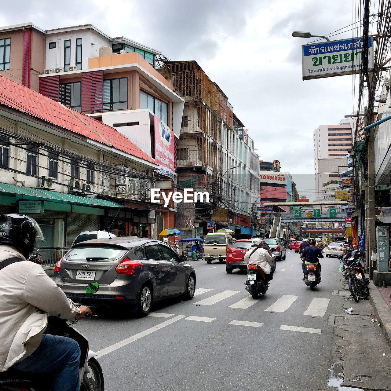 VEHICLES ON CITY STREET AMIDST BUILDINGS