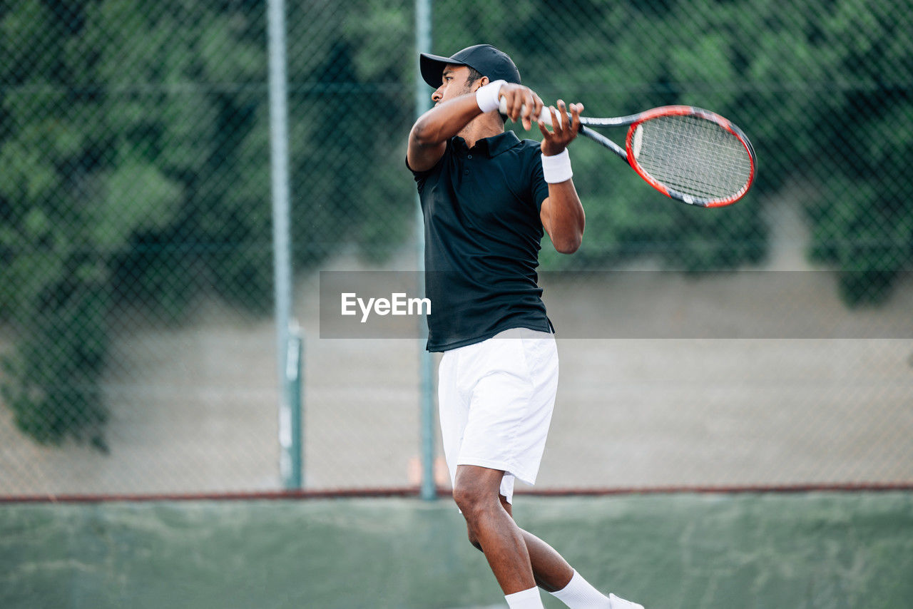 low section of man playing tennis