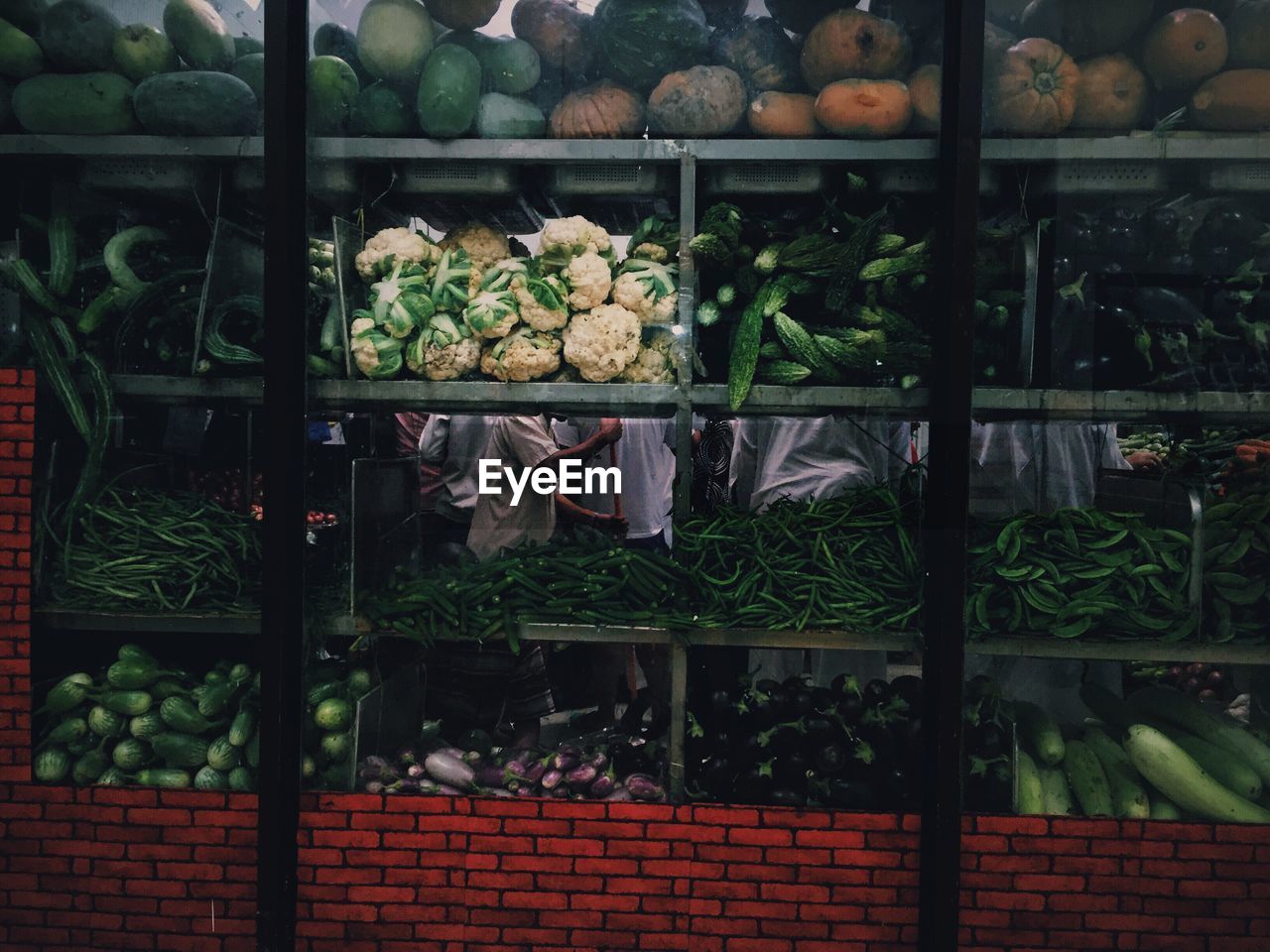 Vegetables in store seen through window glass