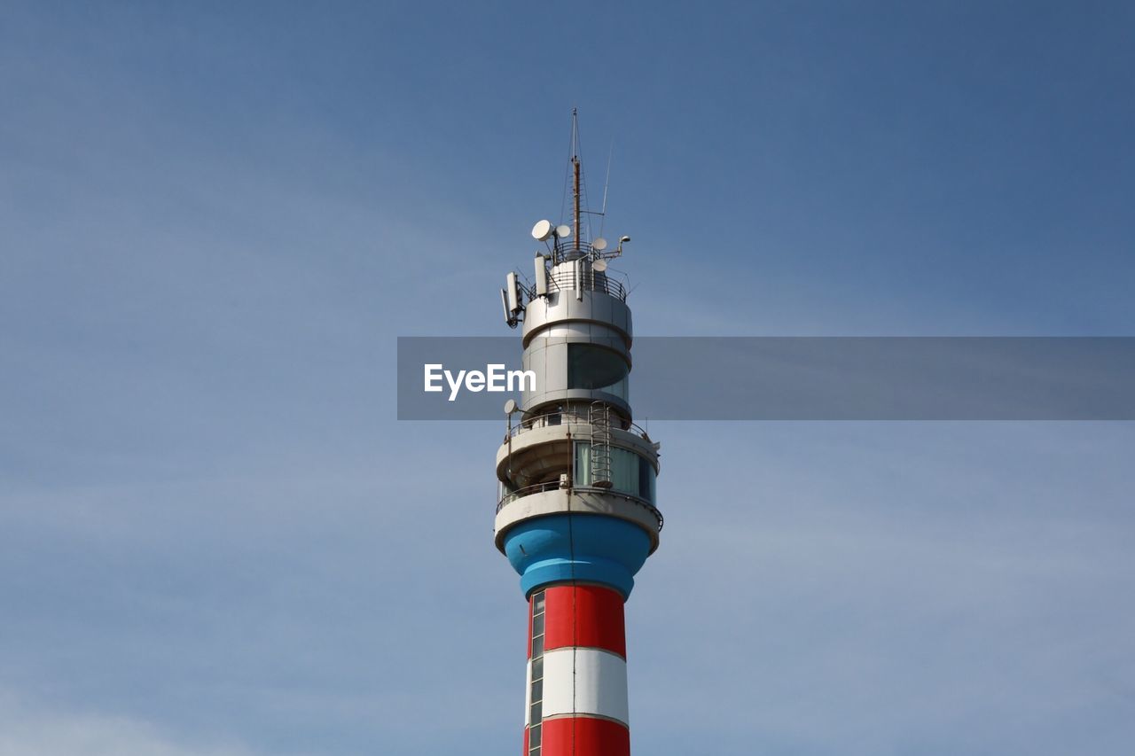 Low angle view of communications tower against sky