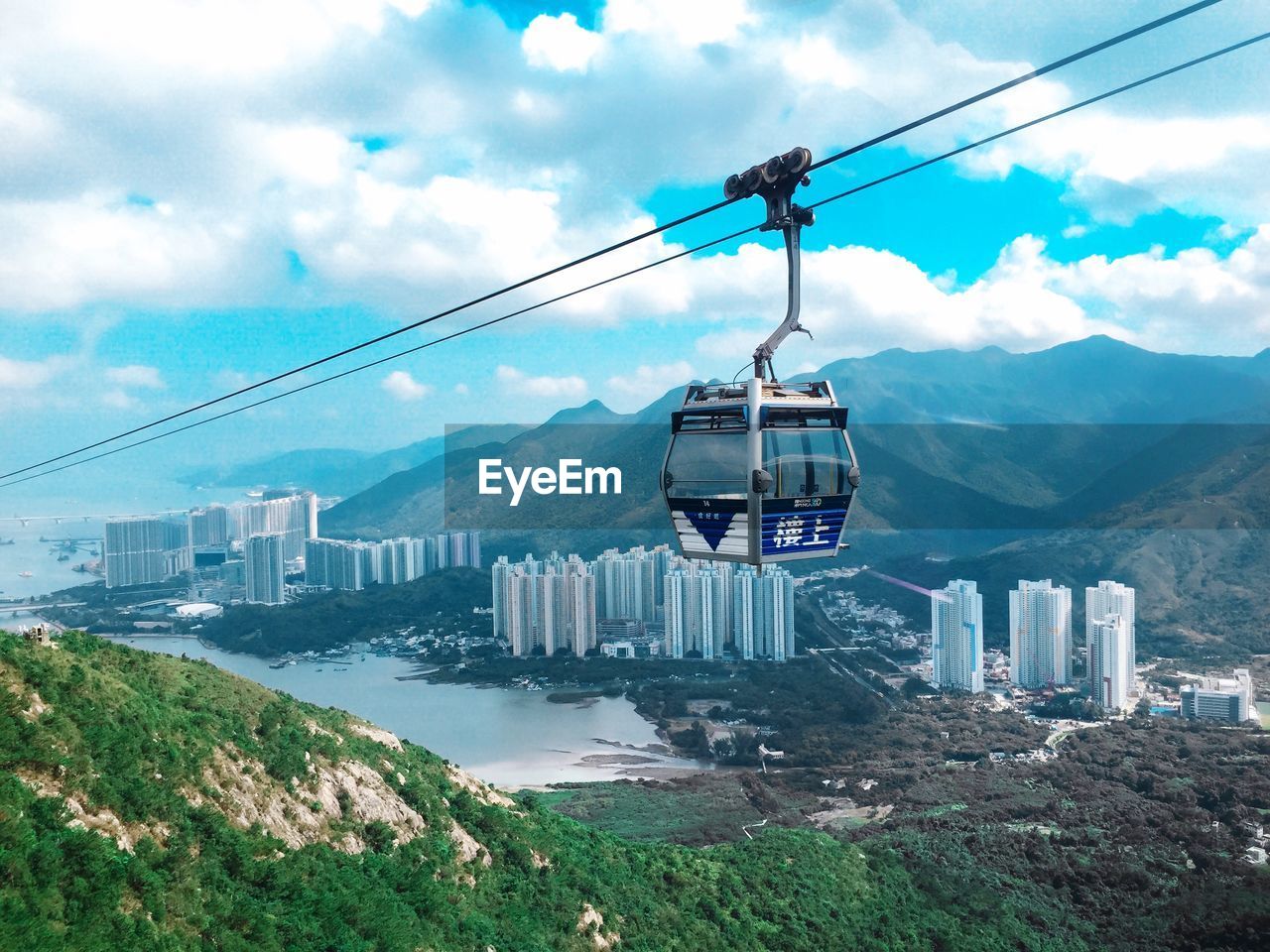 Overhead cable car and buildings against sky