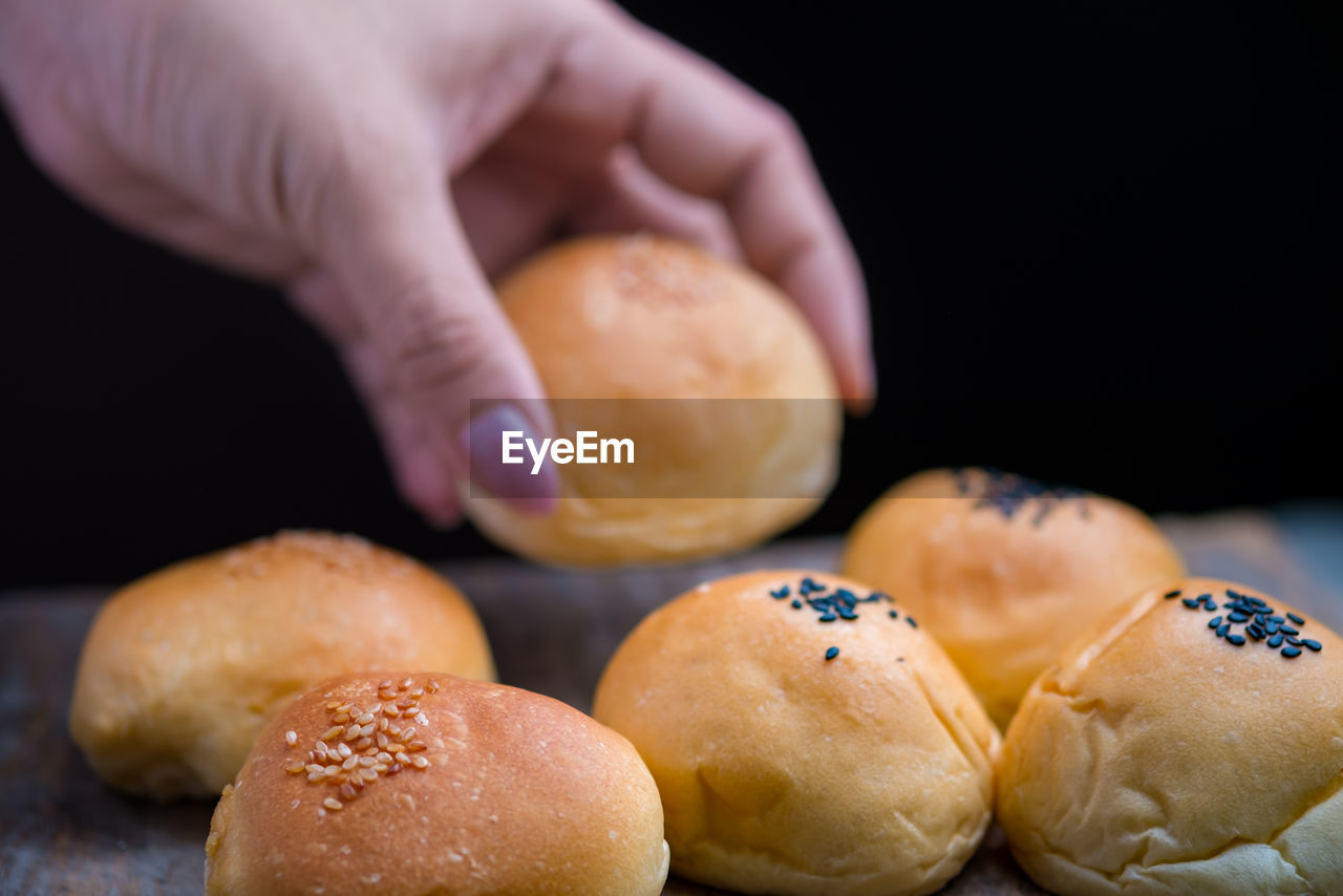 Close-up of hand picking bread