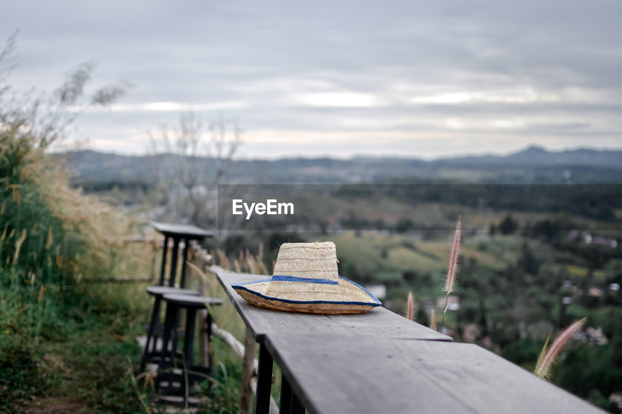 EMPTY CHAIRS AND TABLE AGAINST TREES