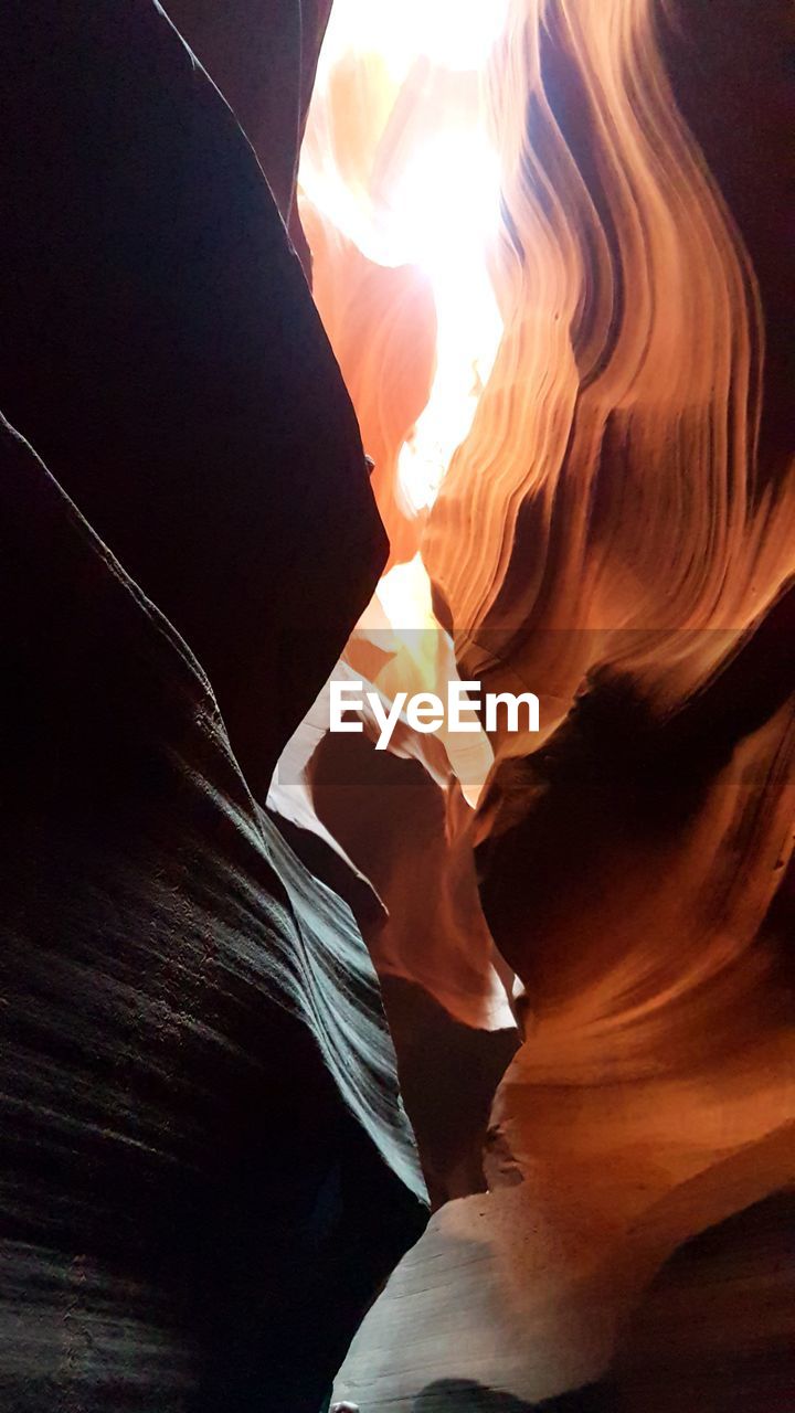 LOW ANGLE VIEW OF ROCK FORMATION IN SUNLIGHT