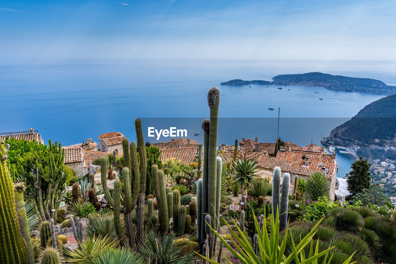 High angle view of townscape by sea against sky