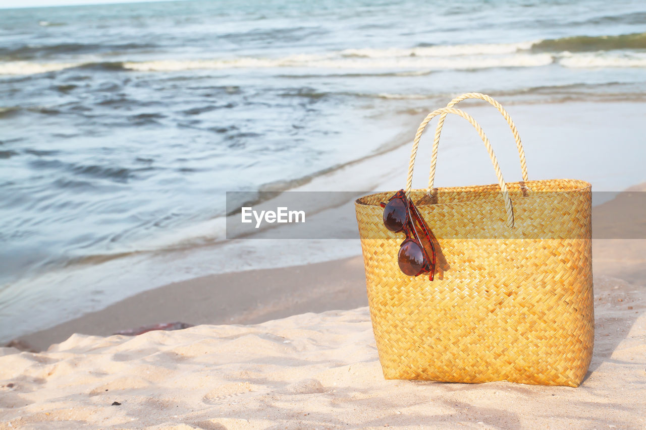 Bag with sunglasses on beach