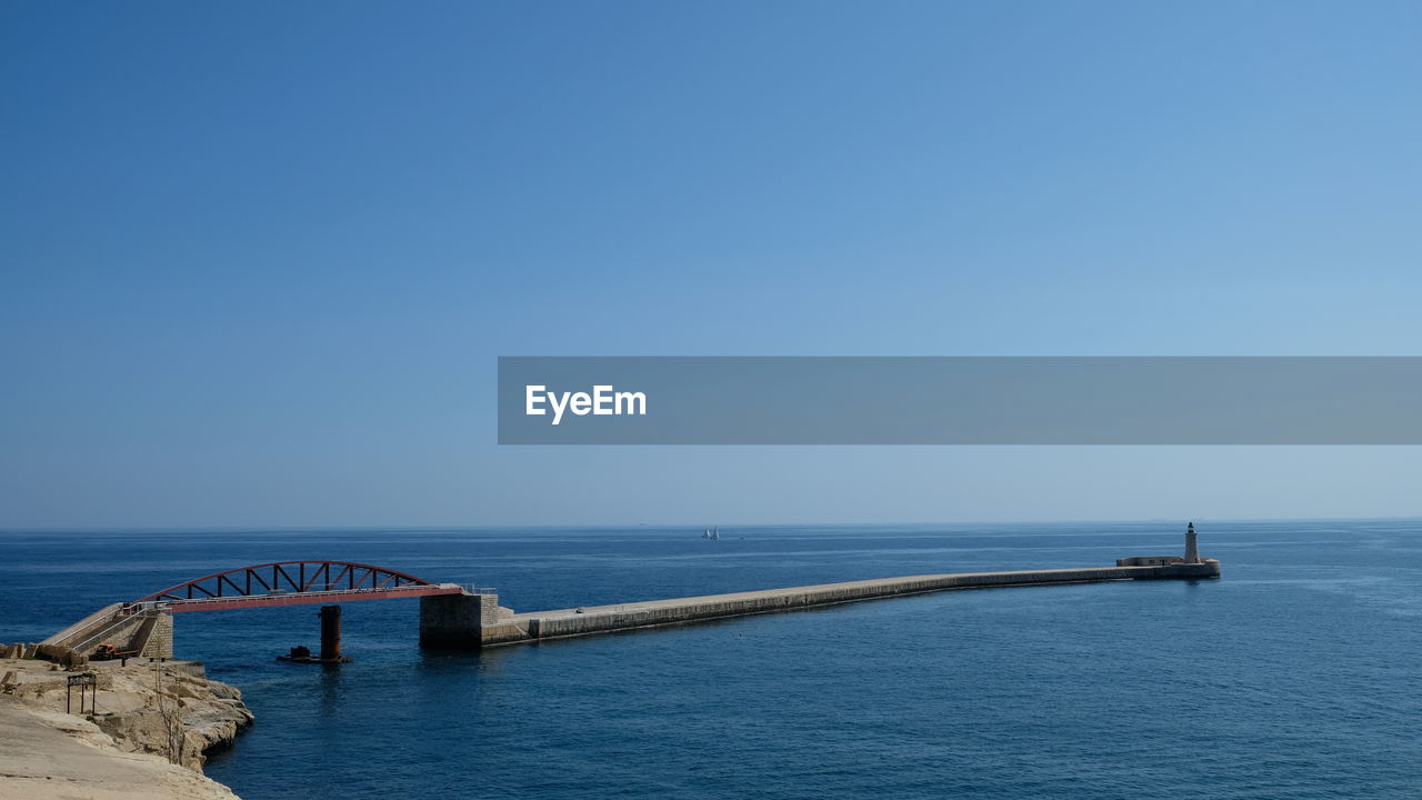 Scenic view of sea against clear blue sky