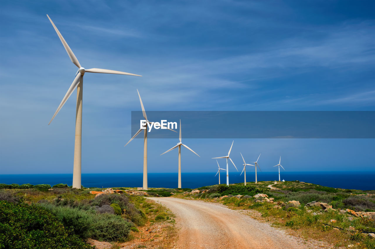 power generation, environmental conservation, turbine, wind turbine, renewable energy, wind power, alternative energy, environment, sky, electricity, wind farm, technology, nature, power supply, wind, power in nature, landscape, environmental issues, windmill, sustainable resources, blue, beauty in nature, land, water, social issues, industry, horizon, cloud, grass, machine, no people, rural scene, transportation, outdoors, plant, sea, road, sunlight, turning, scenics - nature, day, in a row, field, efficiency, architecture, the way forward, propeller