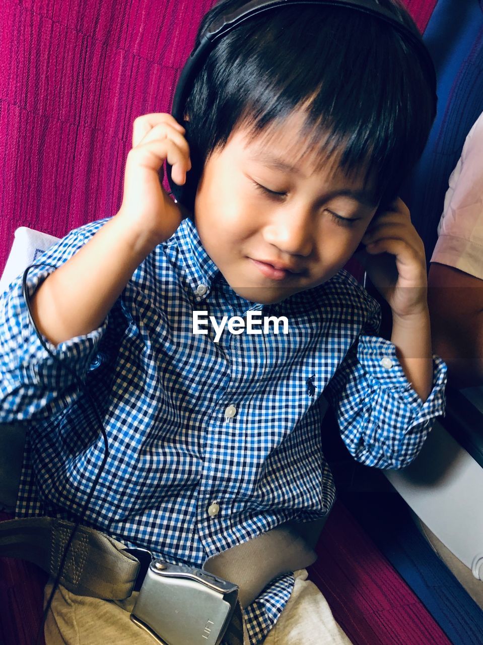 High angle view of cute boy sitting on airplane